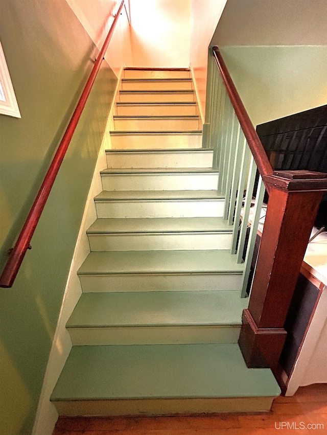 stairway with wood-type flooring