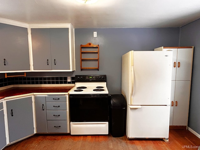 kitchen with gray cabinets, light hardwood / wood-style floors, and white appliances