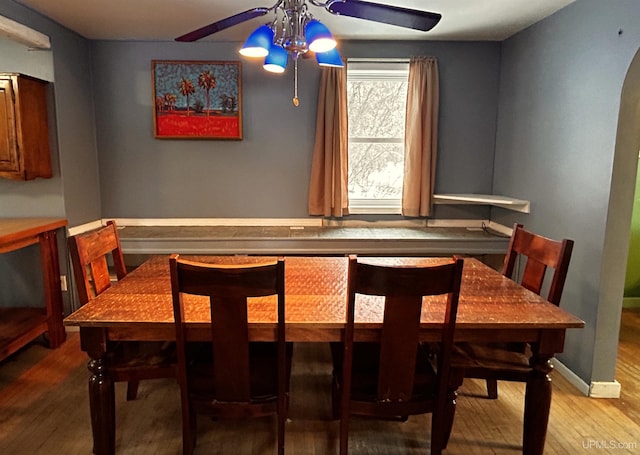 dining space with light wood-type flooring and ceiling fan