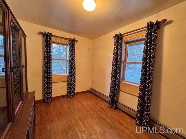 unfurnished room with hardwood / wood-style flooring