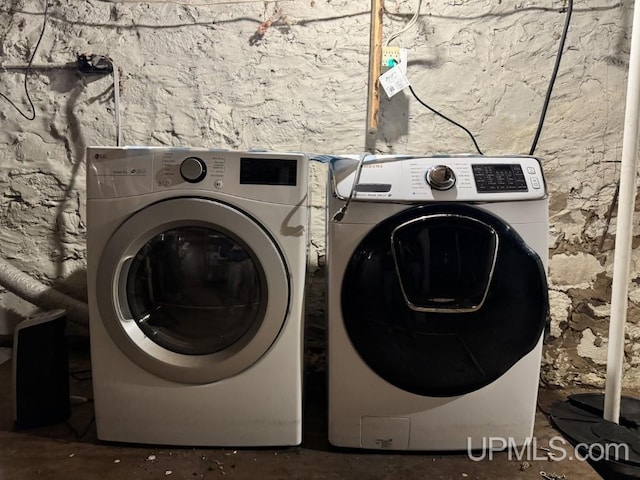 clothes washing area with washing machine and dryer