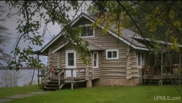 rear view of property featuring a yard