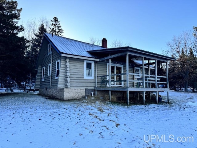 snow covered property featuring a deck