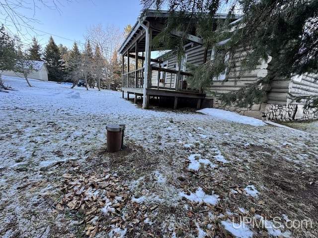 snowy yard with a wooden deck