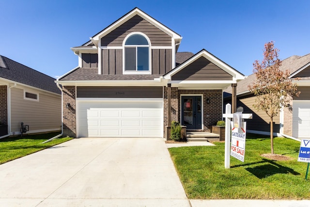 view of front of house with a front lawn and a garage