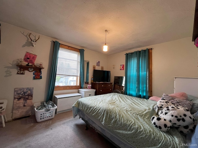 carpeted bedroom featuring a textured ceiling