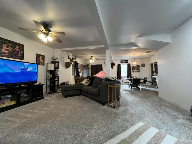 living room featuring carpet flooring and ceiling fan with notable chandelier