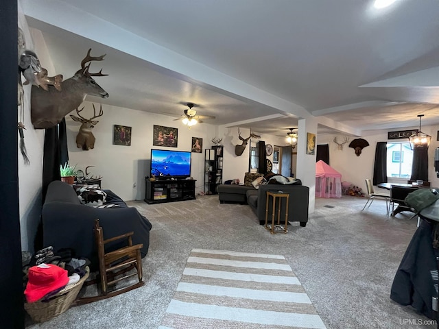 carpeted living room with ceiling fan with notable chandelier