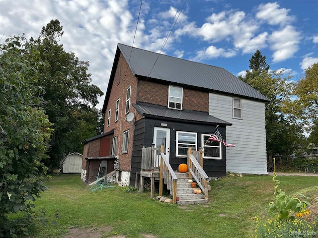 view of front facade with a front lawn and a storage unit