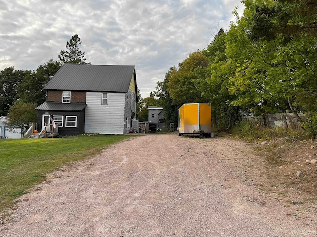 view of property exterior featuring a yard and an outbuilding