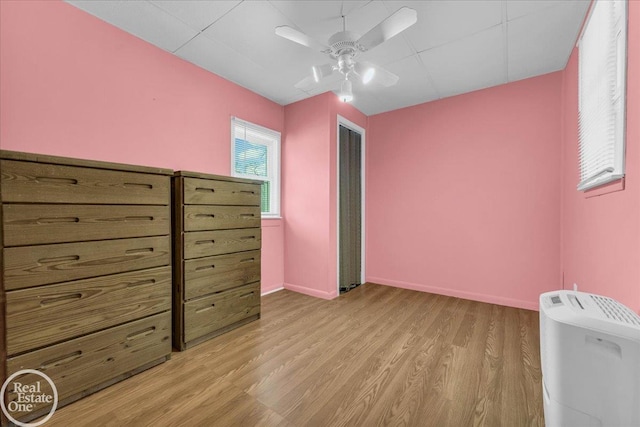 unfurnished bedroom with ceiling fan and light hardwood / wood-style floors