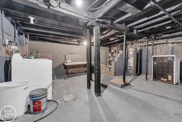 basement featuring washer and dryer and water heater