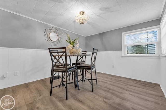 dining room featuring hardwood / wood-style floors and ornamental molding