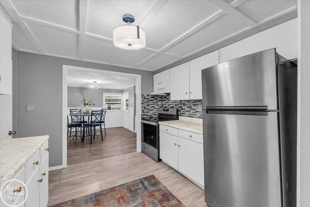 kitchen featuring backsplash, appliances with stainless steel finishes, light hardwood / wood-style floors, light stone counters, and white cabinetry