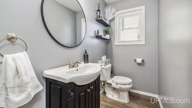 bathroom with vanity, wood-type flooring, and toilet