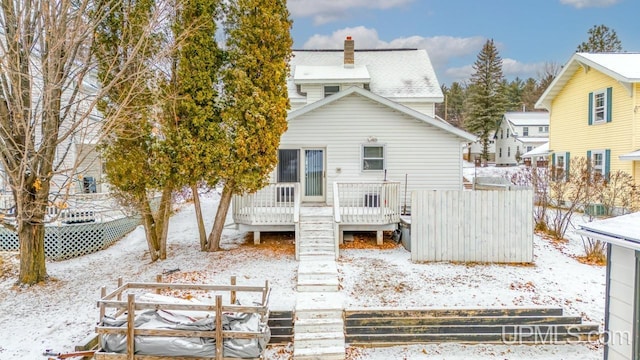 snow covered property featuring a deck