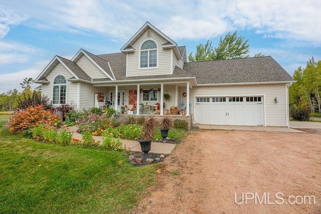 view of front of property with a front lawn, a porch, and a garage