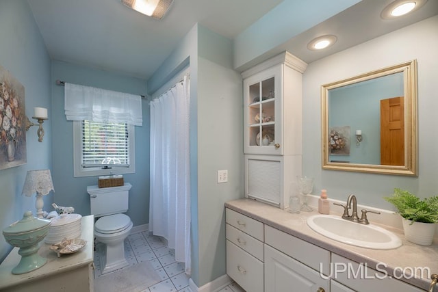 bathroom with tile patterned floors, vanity, and toilet