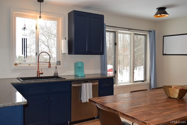 kitchen with blue cabinets, sink, hanging light fixtures, stainless steel dishwasher, and a healthy amount of sunlight