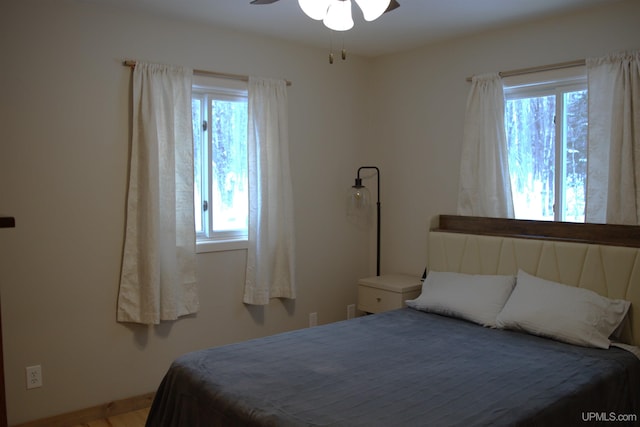 bedroom featuring ceiling fan and multiple windows