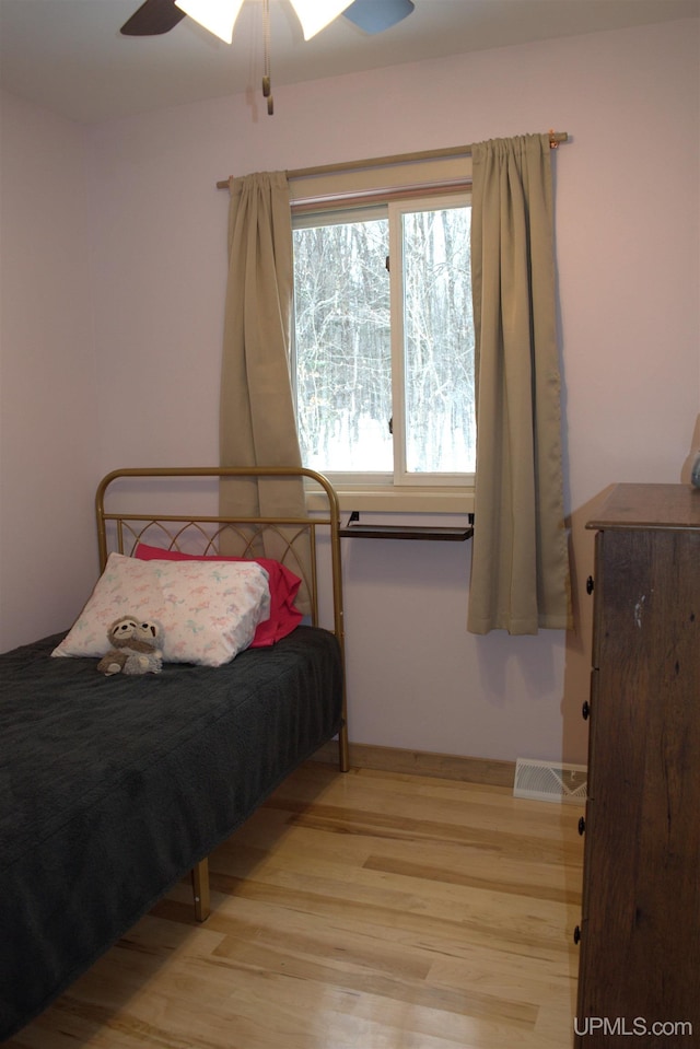 bedroom with ceiling fan and light hardwood / wood-style floors