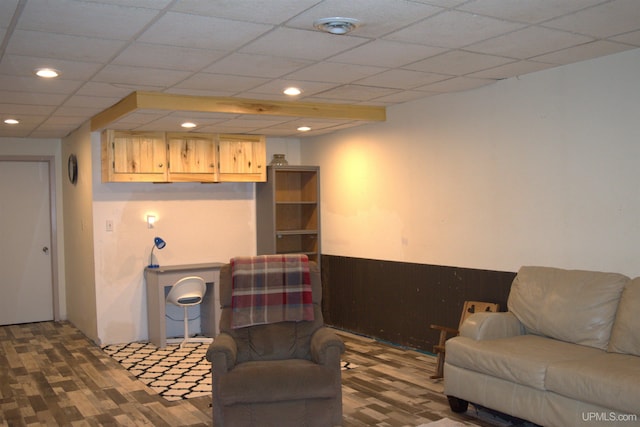 living room with a paneled ceiling