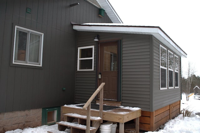 view of snow covered property entrance