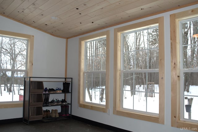 entryway featuring lofted ceiling, a healthy amount of sunlight, and wood ceiling