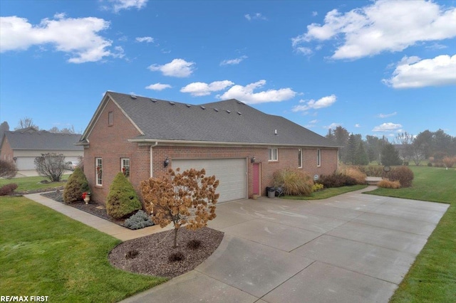 view of home's exterior with a garage and a lawn