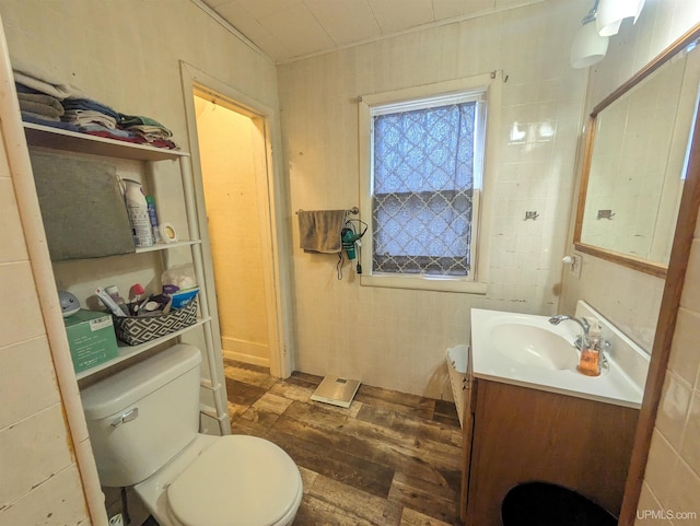 bathroom featuring vanity, hardwood / wood-style flooring, and toilet