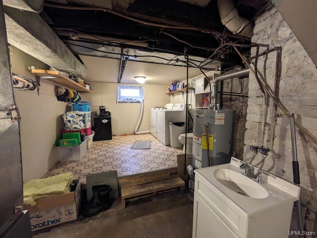 basement with washing machine and dryer, sink, and gas water heater