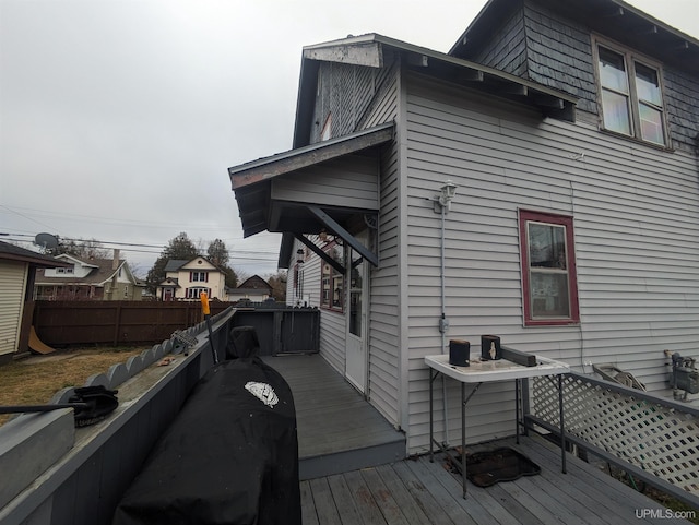 view of side of home featuring a wooden deck