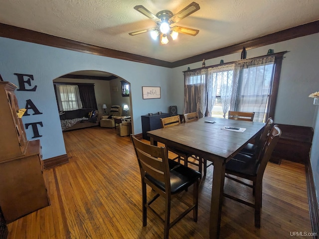 dining room with hardwood / wood-style floors, a textured ceiling, and ceiling fan