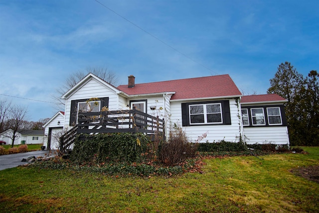 view of front of property with a front lawn, a garage, and a deck