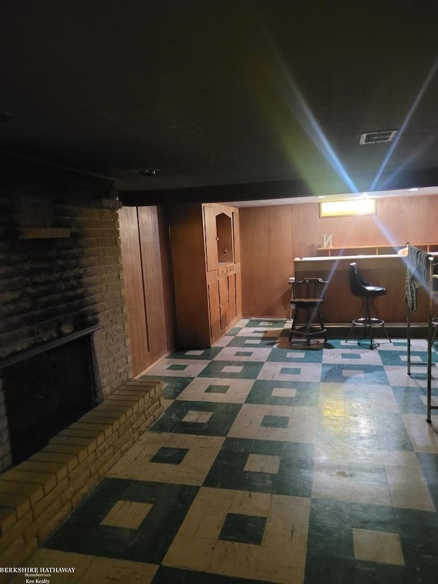 basement featuring wood walls