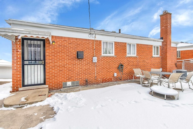 snow covered property featuring central air condition unit