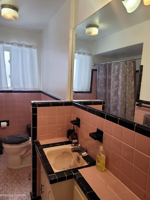 bathroom featuring tile walls, tile patterned flooring, vanity, and toilet