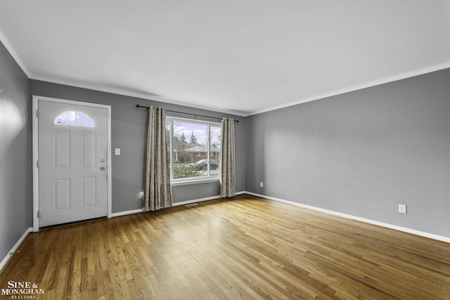 foyer entrance with hardwood / wood-style floors and ornamental molding