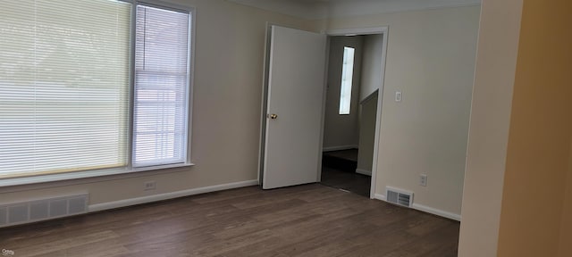 empty room featuring dark wood-type flooring