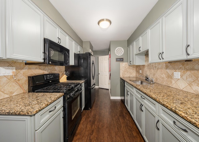 kitchen featuring sink, white cabinets, light stone counters, dark hardwood / wood-style floors, and black appliances