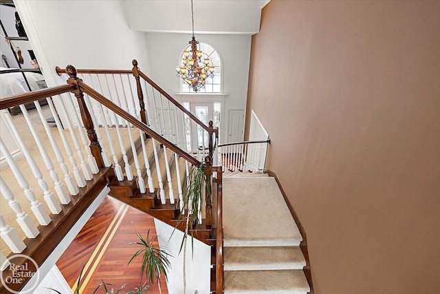 stairway featuring an inviting chandelier