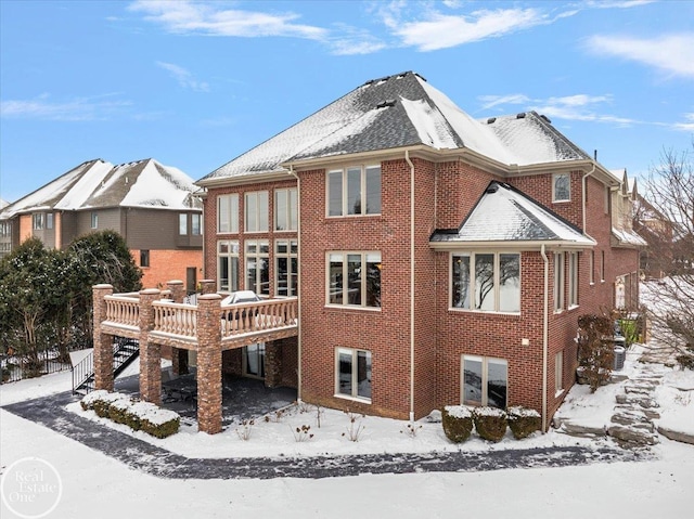 snow covered property featuring a wooden deck