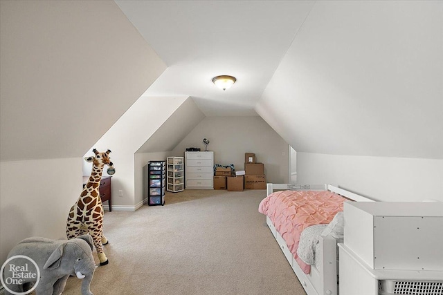 bedroom with light colored carpet and vaulted ceiling