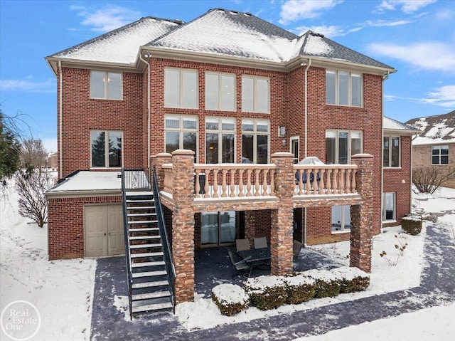 view of snow covered rear of property