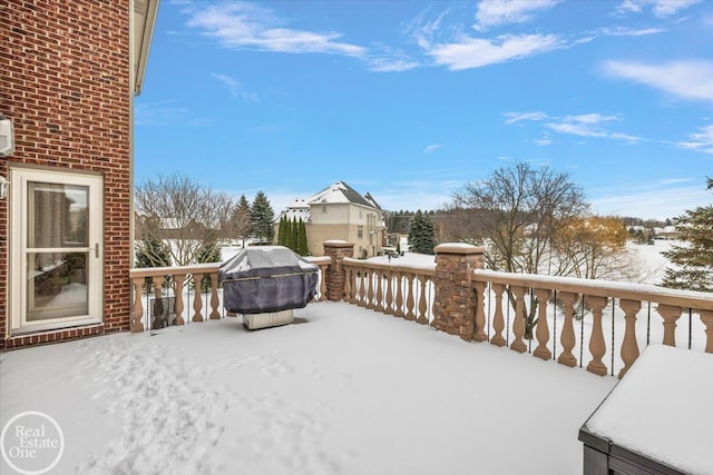 snow covered deck featuring a grill