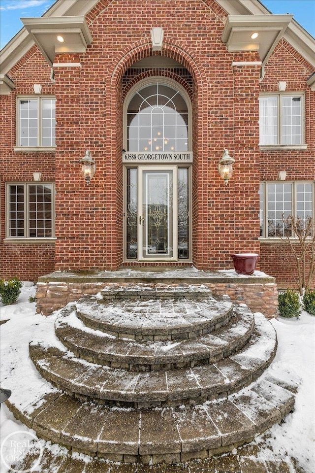 view of snow covered property entrance