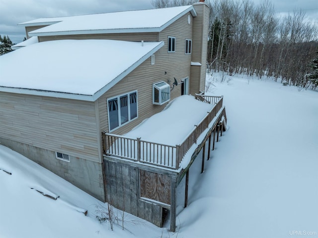 snow covered property with a balcony