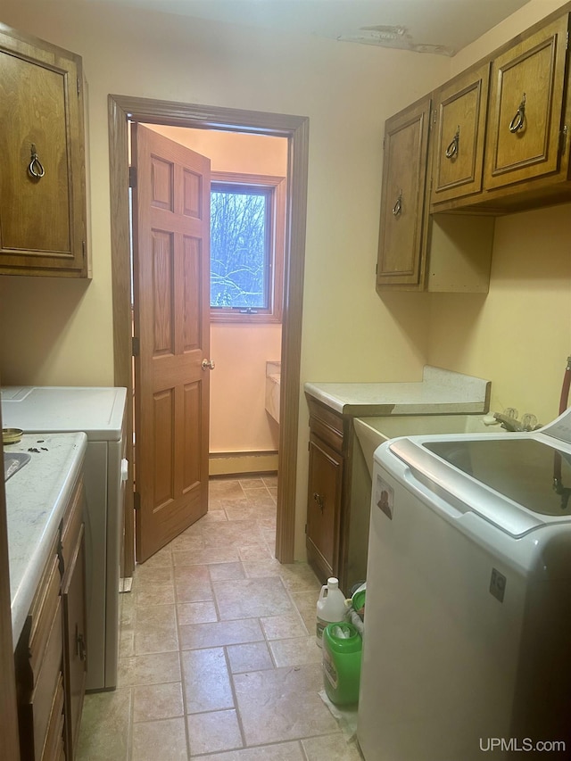 laundry area with cabinets and washer and clothes dryer