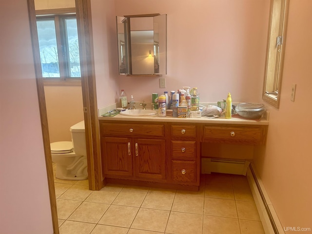 bathroom with toilet, a baseboard radiator, tile patterned floors, and vanity