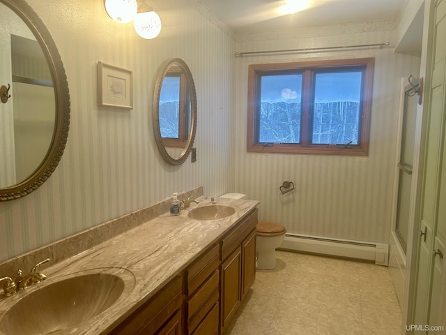 bathroom with toilet, a baseboard radiator, and vanity